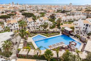 an aerial view of a city with a pool and buildings at Apartamentos Honorio - Pool and Garden in Vilamoura