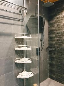 a shower with three shelves in a bathroom at Sweetheart in Saigon in Ho Chi Minh City