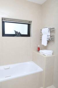 a bathroom with a window and a sink and towels at Luxury Three Bedroom Apartment Foxford County Mayo in Foxford