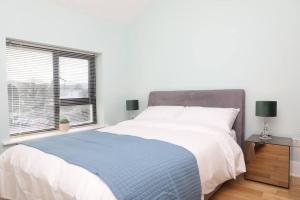 a bedroom with a large bed and a window at Foxford penthouse in Foxford