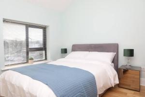a bedroom with a large bed and a window at Luxury Three Bedroom Apartment Foxford County Mayo in Foxford