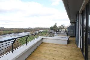 a balcony with a view of a river at Luxury Three Bedroom Apartment Foxford County Mayo in Foxford