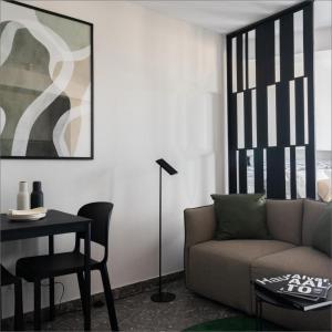a living room with a couch and a table at Park Heights by the Warren Collection in Msida