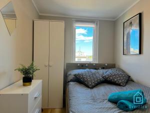 a bedroom with a bed and a window at René Room in Gdańsk