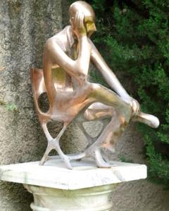 a bronze statue of a woman sitting on a boat at Villa Marinsky Pietrasanta , Lucca in Pietrasanta