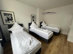 1 dormitorio con 2 camas y lámpara de araña en Bilk Apartment, en Düsseldorf