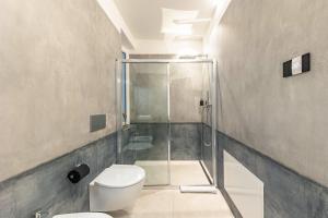 a bathroom with a glass shower and a toilet at App 203 Palazzo Cavour in Bolzano