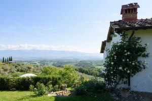 a white building with a view of a valley at La Tuia Vacanze apt for 4PP and apt for 2PP in Montevarchi