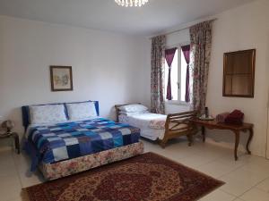 Posteľ alebo postele v izbe v ubytovaní Villa Elisa lago e monti