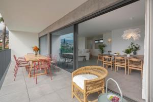 a balcony with a table and chairs and a dining room at CASA DO MIRADOURO 5 by Heart of Funchal in Funchal