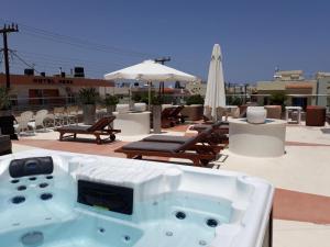 a bath tub sitting on top of a roof at Dionisos Hotel in Malia