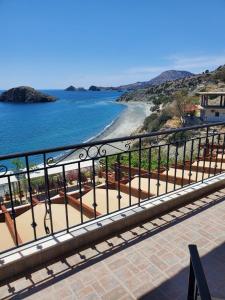 a view of the beach from a balcony at Villa Koutsakis in Kaloi Limenes