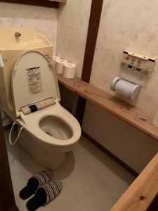 a bathroom with a toilet with a roll of toilet paper at GNARLY OWL 