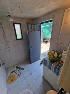 a bathroom with a toilet and a sink and a door at Dream in Chalkidiki 2 bedroom villa with garden in Néa Tríglia