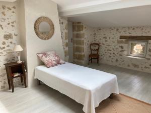 a bedroom with a bed and a chair and a mirror at Domaine sur les coteaux de Loupiac in Loupiac-de-Cadillac +29 photos