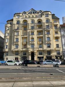 a large building with cars parked in front of it at Casa Perla Danube in Budapest