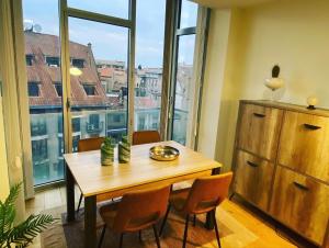 a table and chairs in a room with a large window at Voila Catedral in Tudela