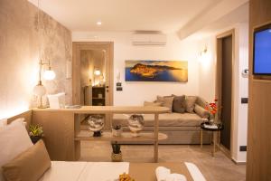 a living room with a couch and a table at Meravigghia Suites Cefalù in Cefalù