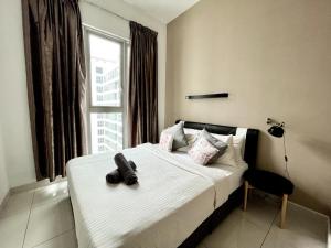 a bedroom with a bed with a teddy bear on it at Regalia Suites & Residences Kuala Lumpur in Kuala Lumpur