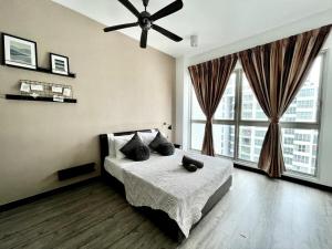 a bedroom with a bed and a ceiling fan at Regalia Suites & Residences Kuala Lumpur in Kuala Lumpur