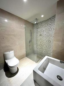 a bathroom with a toilet and a shower and a sink at Regalia Suites & Residences Kuala Lumpur in Kuala Lumpur