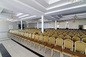 a large room with rows of chairs and chandeliers at Centrum Eventowo- Konferencyjne Pałacyk Fantazja in Sięciaszka Pierwsza