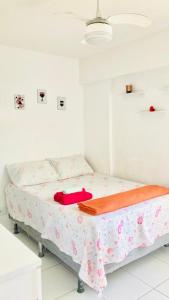 a white room with a bed with a blanket on it at Rio Stay Suíte in Rio de Janeiro