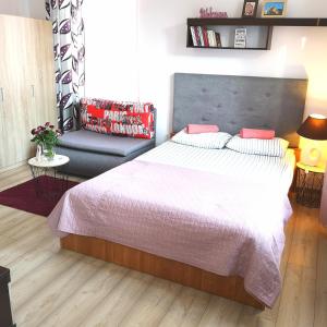 Un dormitorio con una cama grande y un sofá. en STARE MIASTO, en Olsztyn