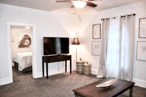 a living room with a television and a bed at Downtown 1 Bedroom Charmer - Walk, Bike, Enjoy!! in Rapid City