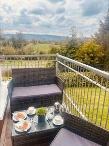 a table with plates of food on a balcony at Maghera House in Enniskillen