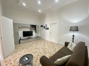 a living room with a couch and a television at Casa Panorama, casa vacanza. in Torre del Greco