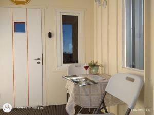 a table with two chairs and a glass of wine at Guesthouse Kohvikann in Palmse