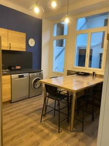 a kitchen with a table and some chairs in a room at Gite de Tom et Mag classé 3 * Clevacances in Pontgibaud