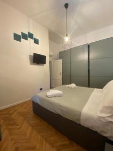 Garibaldi 36 Apartament في سان جيوفاني فالدارنو: غرفة نوم عليها سرير وفوط