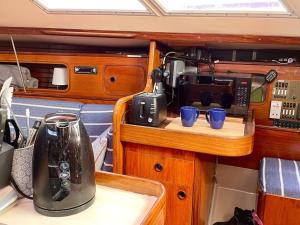 a kitchen with a tea kettle and cups on a counter at The Boat House, Woodbridge, Suffolk in Woodbridge