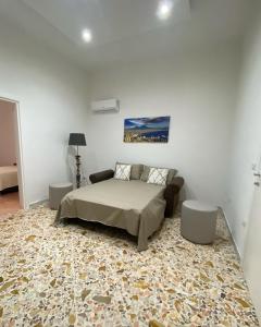 a bedroom with a bed and a rug at Casa Panorama, casa vacanza. in Torre del Greco