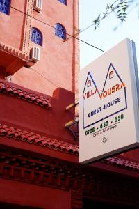 un panneau indiquant une maison d'hôtes sur le côté d'un bâtiment dans l'établissement VILLA YOUSRA, à Marrakech