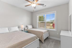 a bedroom with two beds and a window at Crow Creek Carolina Greens in Calabash