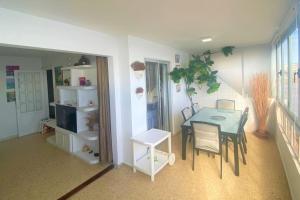 a dining room with a table and chairs in a room at Salinetas, frente al mar y playa in Telde