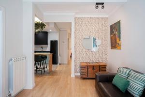 a living room with a couch and a table at Barcelona Eixample in Barcelona