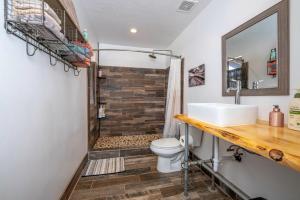 a bathroom with a shower and a toilet and a sink at BaseCamp 37° in Kanab