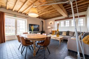 a living room with a table and a couch at Anno 1673 in Evergem
