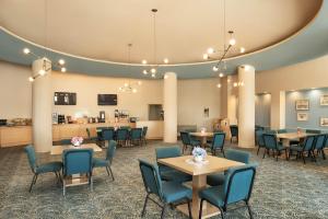 a waiting room with tables and chairs at Sherry Frontenac Oceanfront in Miami Beach