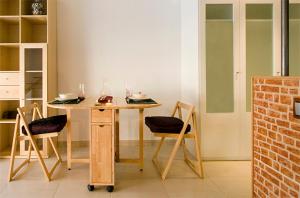 a dining room with a table and two chairs at Reina Amalia Apartment in Barcelona