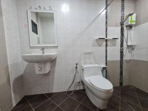 a bathroom with a toilet and a sink at KANA Homehug in Ban Nong Hin