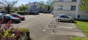 a row of parked cars in a parking lot at Studio au calme in Péronnas