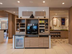 a coffee shop with a counter in a store at Holiday Inn Express Munich - City East, an IHG Hotel in Munich