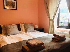 a bedroom with two beds with towels on it at Kutsinska House in Progled