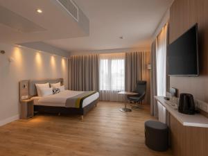 una camera d'albergo con letto e TV di Holiday Inn Express Munich - City East, an IHG Hotel a Monaco