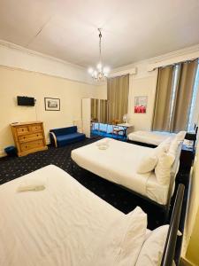 a hotel room with two beds and a tv at Thanet Hotel Annex in London